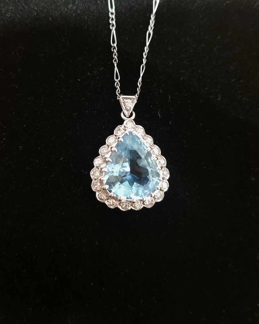Precious pendant photographed against a black background